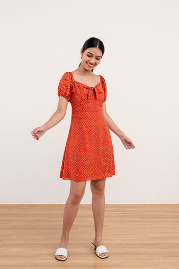 Yacht 21 - Women Clothing Fashion - Sadie Printed Mini Dress in Orange . polka dot , short dress , orange , holiday , casual , puff short sleeves , summer , self-tie ribbon detail , fuss free , wrinkle free , urban resort wear , holiday , vacay , vacation , summer